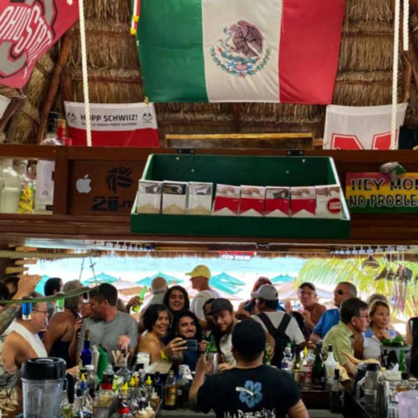 people gather for drinks, conversation, and good times at a beachfront cantina