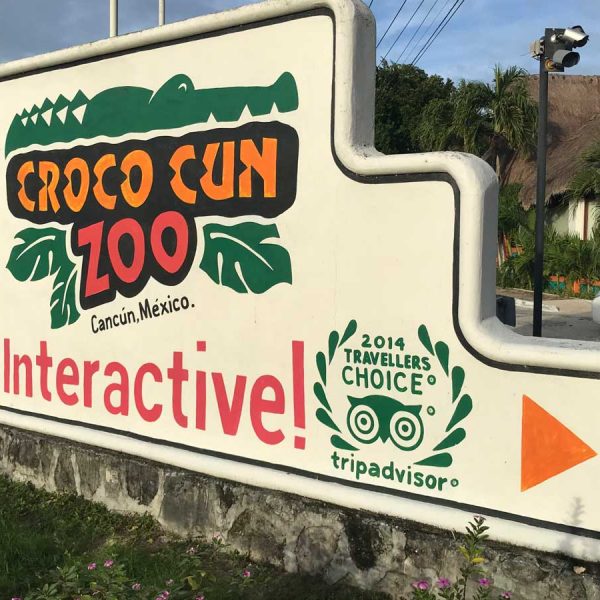 A sign with a painted crocodile welcomes visitors to Croco Cun Zoo