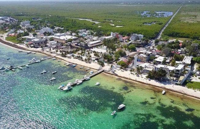 the beaches, docks and prime oceanfront real estate of puerto morelos seen from the air